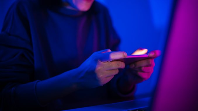 Woman play mobile game Apex Legends, jeu de type Battle Royale, l un des jeux qui seduisent les gamers