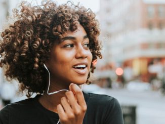 Une jeune fille utilisant son kit mains libres afin de se protéger des ondes émises par un smartphone.