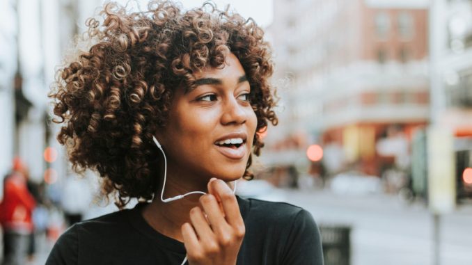 ondes-emises-par-un-smartphone-precautions Une jeune fille utilisant son kit mains libres afin de se protéger des ondes émises par un smartphone.