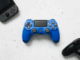 Manette de jeu bleu, noir et console portable grise.